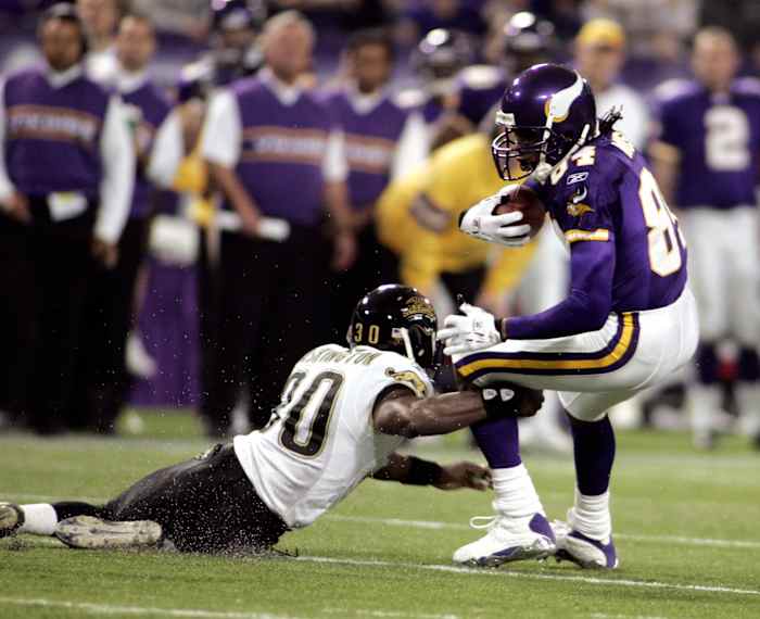 Minnesota Vikings wide receiver Randy Moss avoids a Jacksonville Jaguars defender.